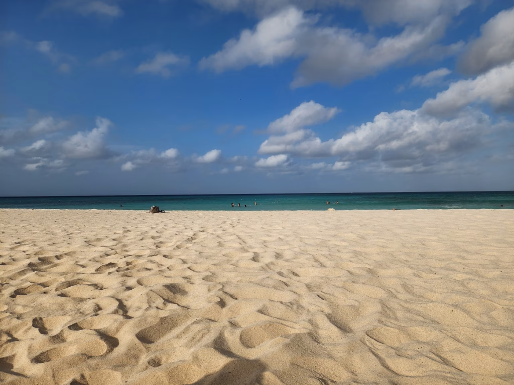 Beach view comparing Palm Beach high-rise hotels and Eagle Beach low-rise resorts in Aruba