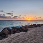 Calm turquoise water and empty beach in Aruba during low season